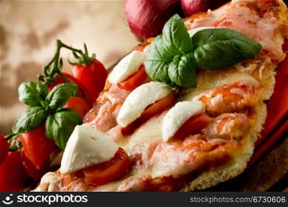 delicious slice of pizza with buffalo mozzarella and cherry tomatoes on wooden table