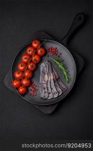 Delicious smoked or cured mahan horse meat sausage with spices and herbs on a dark concrete background