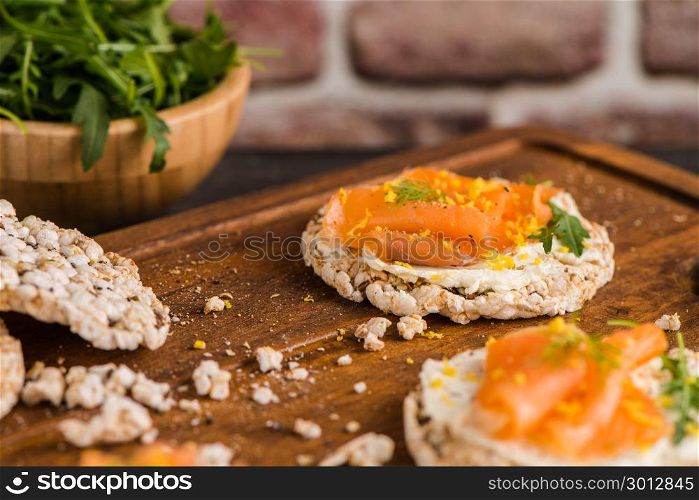 Delicious smoked salmon and cream cheese on rice bread toasts.