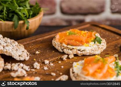 Delicious smoked salmon and cream cheese on rice bread toasts.