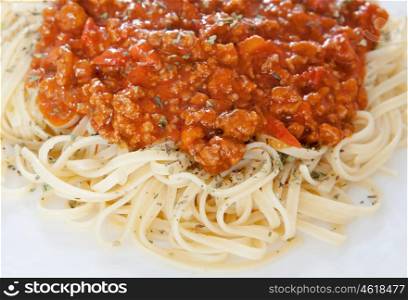 Delicious spaghetti with meat and tomato on a white plate