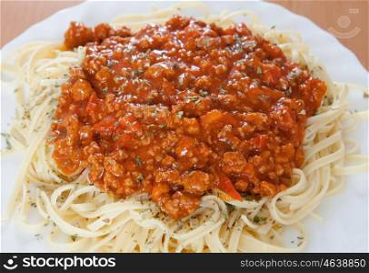 Delicious spaghetti with meat and tomato on a white plate
