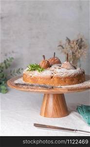 Delicious spice cake with pear, ginger and cinnamon on a white kitchen counter.