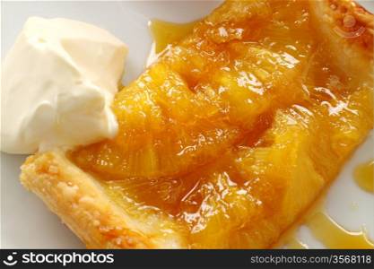 Delicious spiced pineapple galette served with cream .