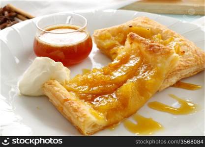 Delicious spiced pineapple galette served with cream and pineapple syrup.