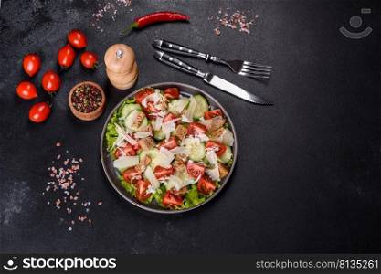 Delicious spring fresh vegetable salad with cherry tomatoes, cucumber, breadcrumbs and parmesan cheese on a dark concrete background. Delicious spring fresh vegetable salad with cherry tomatoes, cucumber, breadcrumbs and parmesan cheese