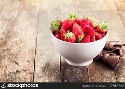 delicious strawberries on brown old wooden table
