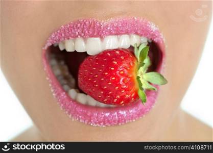 Delicious strawberry fruit in pink woman mouth and teeth