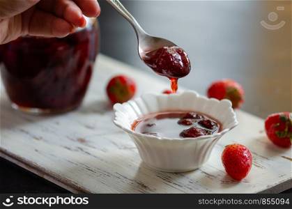 Delicious Strawberry Jam in the jar on the table.