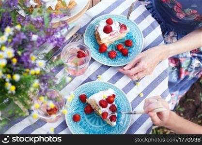 delicious summer. girls eating cake in the garden