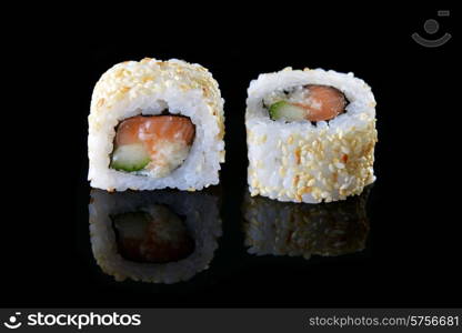 Delicious sushi rolls on black background