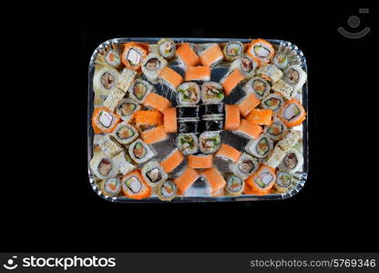 Delicious sushi rolls on black background