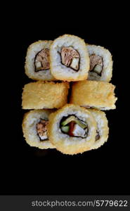 Delicious sushi rolls on black background