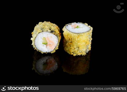 Delicious sushi rolls on black background