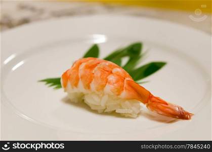 delicious sushi with tiger shrimp on white plate