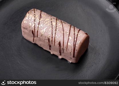 Delicious sweet cheese with syrup covered with chocolate and nuts on a ceramic plate on a dark concrete background