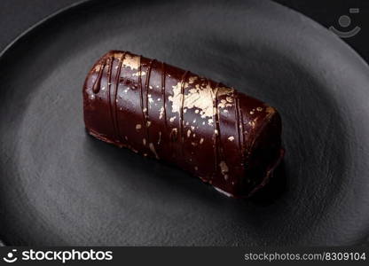 Delicious sweet cheese with syrup covered with chocolate and nuts on a ceramic plate on a dark concrete background