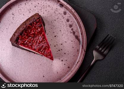Delicious sweet cheesecake cake with mascarpone cheese, raspberries and jam on a dark concrete background