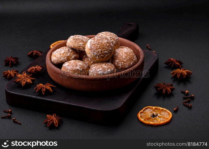 Delicious sweet round gingerbread with jam inside on a dark concrete background