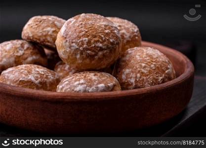 Delicious sweet round gingerbread with jam inside on a dark concrete background