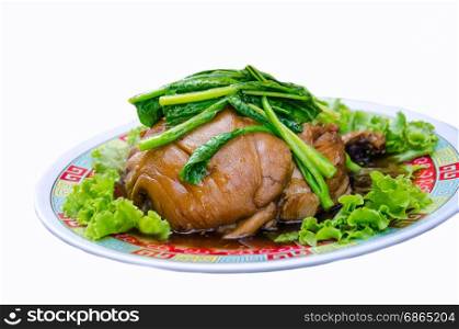 delicious Thai food call KHAMOO from boiled pork with herbal ingredient and vegetable on white background