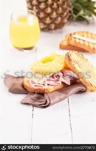 Delicious Toast Hawaii on wooden table with juice