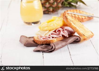 Delicious Toast Hawaii on wooden table with juice
