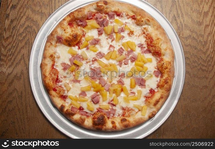 Delicious tomato sauce cheese covered hot and tasty Hawaiian pizza pie . Pizza and Beer 