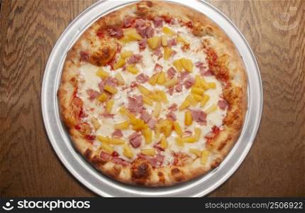 Delicious tomato sauce cheese covered hot and tasty Hawaiian pizza pie . Pizza and Beer 