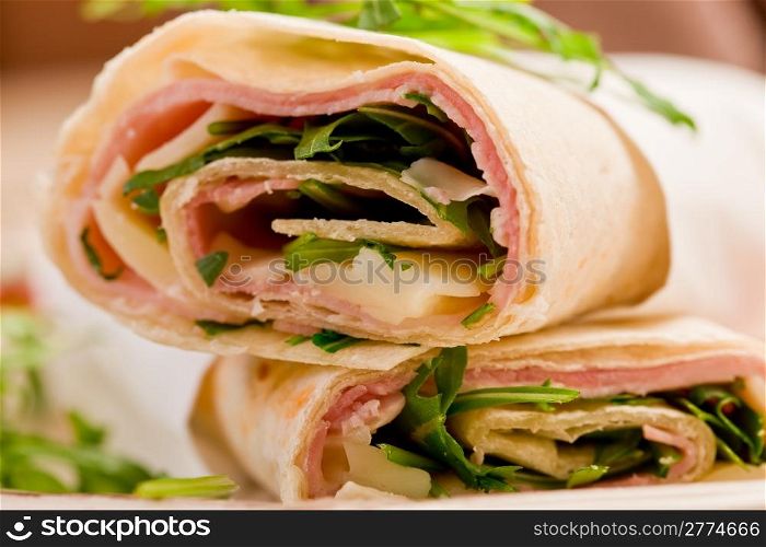 Delicious tortillas stuffed with bacon and colorful arugula salad