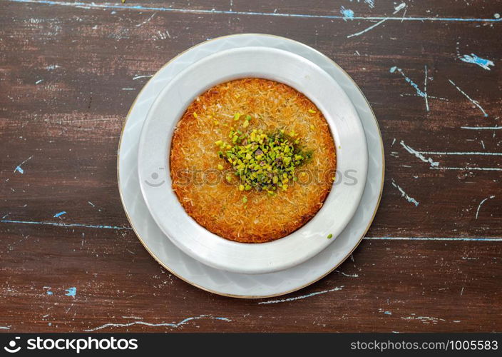 Delicious traditional Turkish dessert: Kunefe kadayif with pistachio and cheese