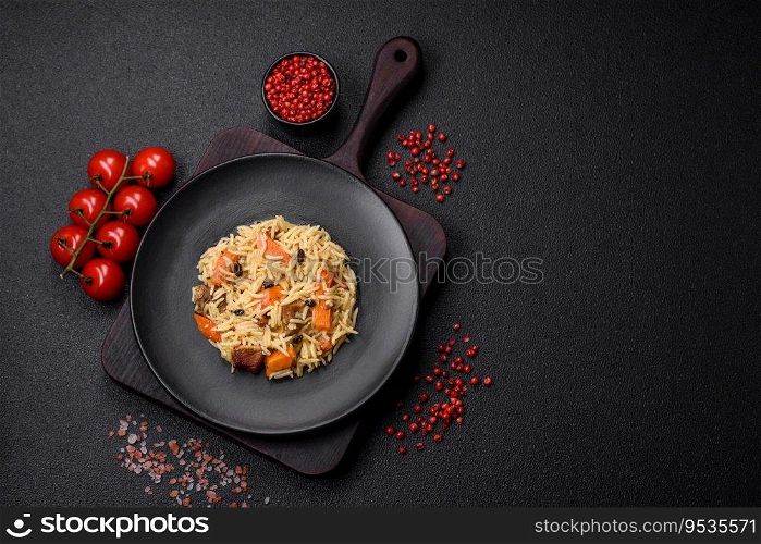 Delicious Uzbekπlaf withχcken, carrots, barberry, sπces and herbs on a dark concrete background