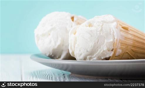 delicious vanilla ice cream cones laying plate