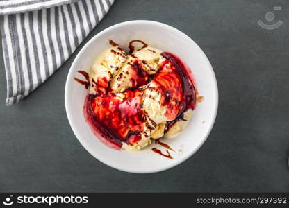 delicious vanilla ice cream with raspberry sauce and choco stripes