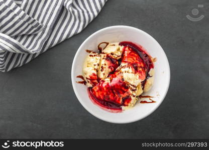 delicious vanilla ice cream with raspberry sauce and choco stripes