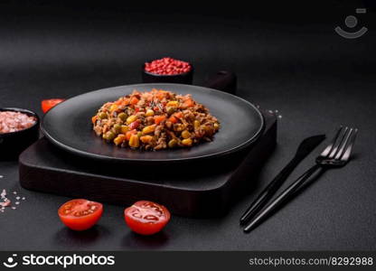 Delicious veggie salad with canned tuna and mexican vegetable mix on dark concrete background