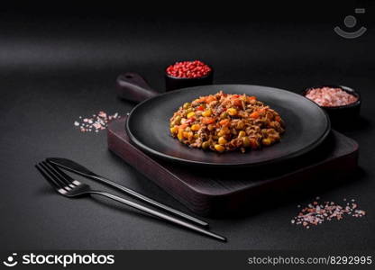 Delicious veggie salad with canned tuna and mexican vegetable mix on dark concrete background