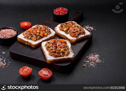 Delicious veggie sandwiches with canned tuna and Mexican mixed vegetables on a dark concrete background