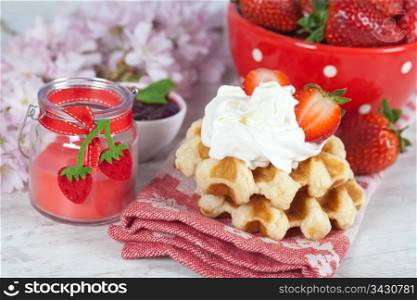 Delicious waffle with whipped cream and strawberries
