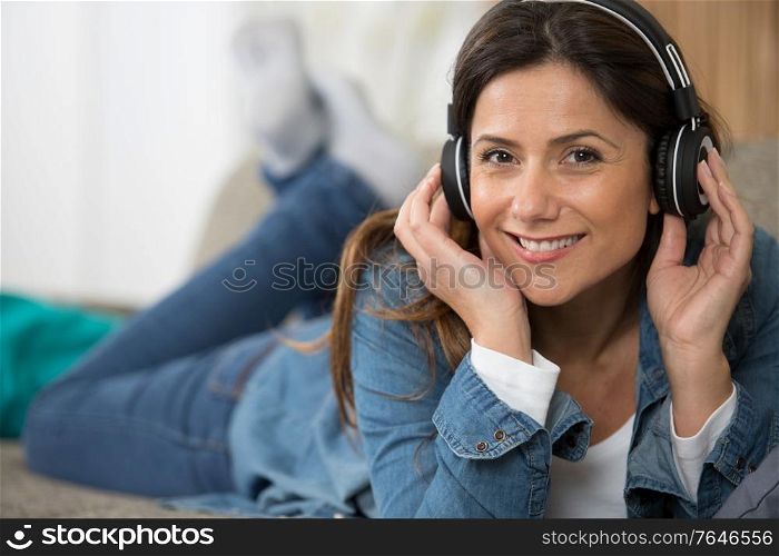 delighted woman listening to music with headphones