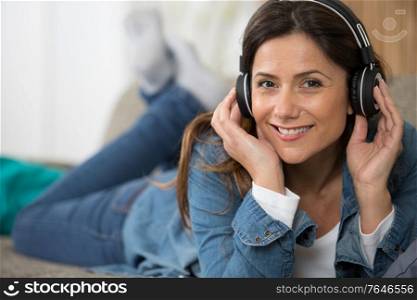 delighted woman listening to music with headphones