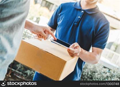 Delivery Asian man service with boxes in hands standing in front of Customer&rsquo;s house doors