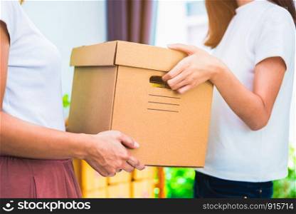 Delivery box of products and women hands when service at home or office. Business and Marketing concept. Online shopping and Express delivery theme