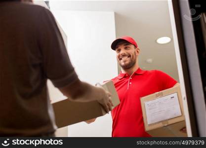 delivery, mail, people and shipping concept - happy man delivering parcel boxes to customer home. happy delivery man giving parcel box to customer
