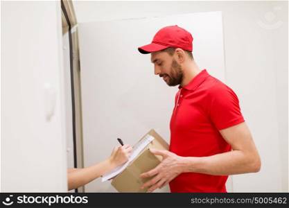 delivery, mail, people and shipping concept - happy man with box and customer signing form at home. delivery man with box and customer signing form