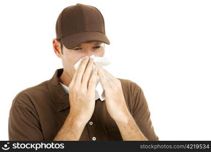 Delivery man at work, blowing his nose in a tissue. Isolated on white.