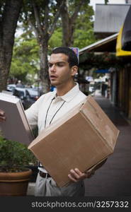 Delivery man carrying large box