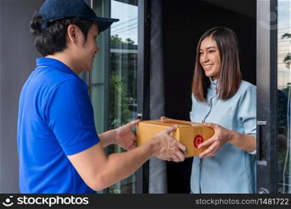 Delivery man delivering a parcel box to customer woman at home