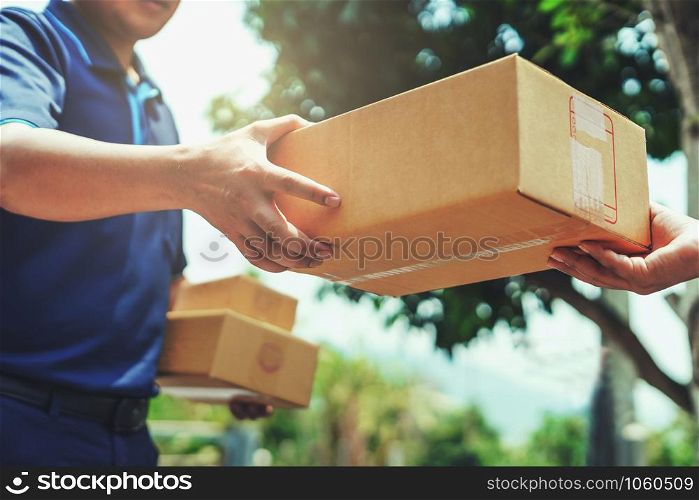 Delivery man delivering holding parcel box to customer