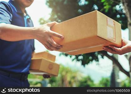 Delivery man delivering holding parcel box to customer